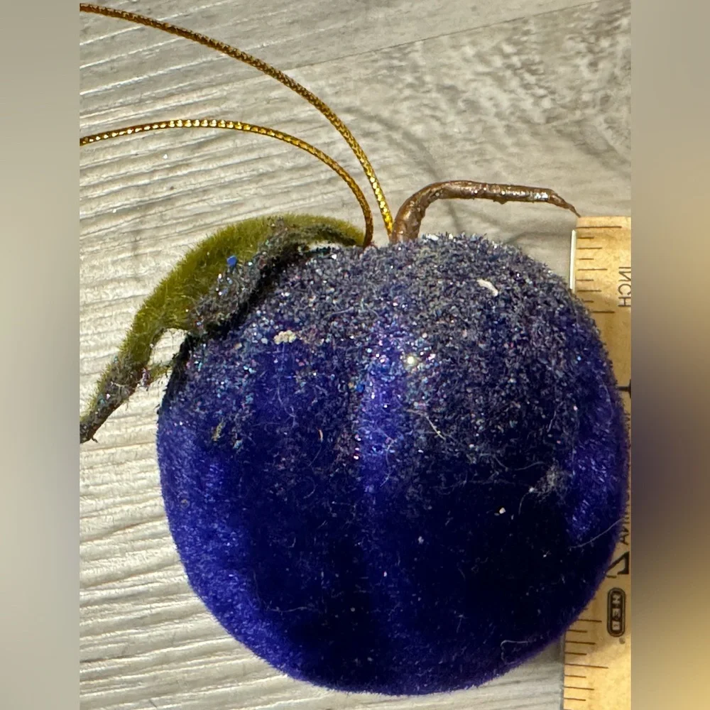Christmas tree ornament. A plum-shaped ornament covered in glitter. The ornament